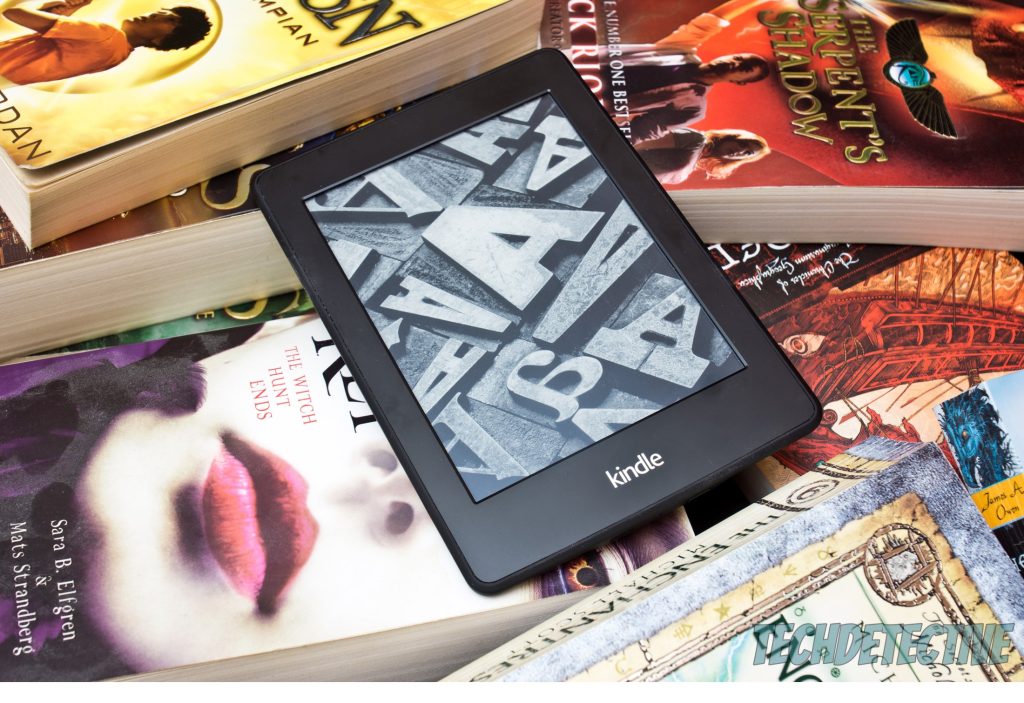 An Amazon Kindle over several books